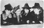 Group portrait of four young Jewish women in the Sosnowiec ghetto.