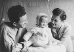 Bernard and Cesia Kaiser pose with their infant, Jurek, in the Kielce ghetto.