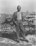 Portuguese diplomat Carlos de Liz-Texeira Branquinho poses on a hilltop overlooking a city.