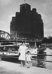 Berta Fiedler, a Jewish refugee from Vienna, poses with her son Harry on a bridge at the waterfront in Shanghai.