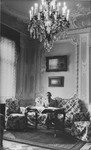 Consul Charles (Carl) Lutz sitting on a sofa in his office which was located in the American embassy in Budapest.