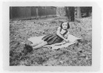 Gisela Soldinger rests on the grass in Bilzen where her family was forced to live in anticipation of deportation back to Germany.