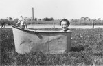 Lotte Gottfried (left) and Roszi Kaufmann sit in a tub along the banks of the Prut River in Czernowitz.