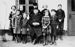 Herbert and Ruth Karliner (front row, left) pose with a group of children and an unidentified man outside a building in Peiskretscham, Germany.