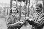 Women survivors in the womens' camp in Woebbelin hold an orange given to them by an American soldier.