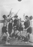 Jewish youth play a game of ball on a beach in Riga.