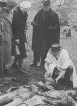 Hungarian civilians identify the corpses of Jews exhumed from a mass grave.