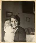 Close-up portrait of a Czech-Jewish mother holding her infant son.