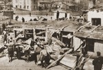 Polish laborers cart away furniture and dismantle buildings after the liquidation of the Lublin ghetto.