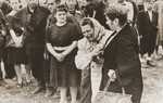 A woman cries in grief for the loss of her husband and other victims of the Kielce pogrom during the public burial.