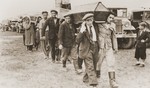 Pallbearers carrying the the victims of the Kielce pogrom, transport the coffins from trucks to the burial site in the Jewish cemetery.