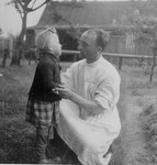 A physician looks at a little girl in theTrzebnia sub-camp of Auschwitz.