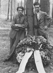 Willie Sterner (right) and a friend pose next to a wreath at the Gunskirchen concentration camp during a commemoration for its Jewish victims.