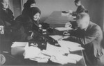 Jews obtaining work permits or ID cards in an administrative office in the Krakow ghetto.