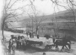 Romanian workmen load coffins onto a cart to be transported to the Jewish cemetery in Dej.