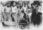 Jewish teenagers work a field in Switzerland following their liberation from Buchenwald in preparation for their immigration to Palestine

Among those pictured is Abraham Grajz (second from the right).