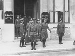 Heinrich Himmler with other Nazi officials stand in front of the "Grand Hotel" in an unidentified location.