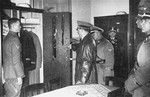 Adolf Hitler inspects a locker during a visit to his SS Leibstandarte (bodyguard unit).