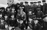 Adolf Hitler poses with a group of sailors aboard a German armored cruiser, the Deutschland.