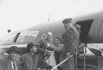Israeli emissary Barzelai greets Jewish DPs as they board the first air transport of new immigrants to Israel from Germany.