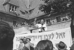 A speaker addresses a crowd at a rally celebrating the founding of the State of Israel, outside the headquarters of the Central Committee of the Liberated Jews in the US Zone of Germany located on the Moehlstrasse in Munich.