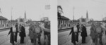 Stereoscopic photograph of Polish civilians passing through a German checkpoint on a Warsaw city street.