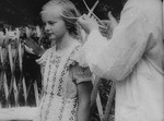 The head of a young Polish girl is measured using a caliper during her racial examination by German authorities.