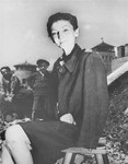The Hungarian Jewish stage actress from Budapest, Livia Nador, sits outside on a stool at the newly liberated Mauthausen concentration camp.