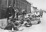 Survivors in Mauthausen rest outside a barrack after the liberation of the camp.