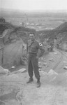 An American soldier poses near the edge of the "parachute jump" at the Wiener Graben quarry in Mauthausen.
