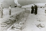 Nuns from a nearby convent view the bodies of former inmates in an open mass grave that has been prepared by Austrian civilians at the Mauthausen concentration camp.