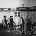 On orders from the U.S. Army, Austrian citizens remove corpses from the "Russian camp" section of Mauthausen for burial in a mass grave.