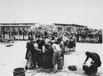 In the women's camp at Mauthausen, survivors queue up for soup.