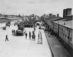 An American tank rolls down the main street of the Mauthausen concentration camp.