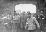 Mauthausen survivors greet American soldiers as they enter the gates of the concentration camp.