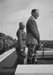 Chancellor Adolf Hitler and Reichsarbeitsfuehrer Generalmajor Konstantin Hierl stand before 47,000 members of the German Labor Service at Reichsparteitag (Reich Party Day) ceremonies in Nuremberg.