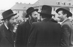 A group of rabbis converses outside at the Bergen Belsen displaced persons camp during a demonstration protesting the return of the Exodus 1947 passengers to Germany.