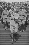 With his hand raised in a salute, Chancellor Adolf Hitler walks down the steps to the Zeppelinfeld during Reichsparteitag (Reich Party Day) ceremonies in Nuremberg.