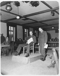 Prosecutor William Denson and another of the American team examine documents during the Dachau trial.