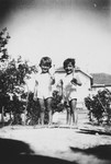 Peretz and Eliyahou Siaky pose in the garden with their shovels.