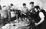 Men learn industrial knitting in an ORT vocational program in the Windsheim displaced persons' camp.