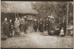 The extended Butnaru family poses outside the home of Max Dulberg (the donor's uncle) in Husi, Romania with grapes and wine making tools.