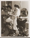 Mary Campo teaches a hairstyling class at the Fort Ontario refugee center.