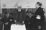 Jewish council chairman Mordechai Chaim Rumkowski, delivers a speech after receiving a presentation album at a ceremony in the Lodz ghetto.