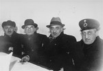 Four members of the Lodz ghetto administration seated at a table.