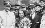 Leon Rozenblat, chief of the ghetto police (left), poses with a newly wed couple in the Lodz ghetto.