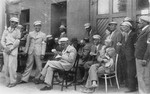 Mordechai Chaim Rumkowski (seated in the center), attends an event with members of the Jewish police and Sonderkommando.