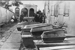 Coffins for the victims of the Kielce pogrom are laid out in a courtyard.