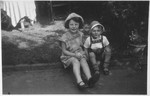 Two young Jewish children sit outside their home in Moenchengladbach, Germany.