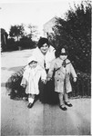 Vanda Pacifici poses with her children Emanuele and Miriam on a street in Rhodes.